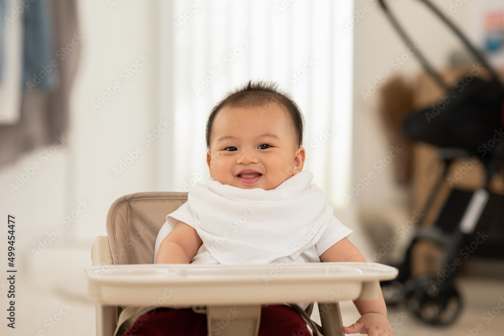 Happy asian newborn baby sit on baby chair smile and laughing with parent or family at home.Adorable baby boy cheerful enjoy with good moment in warmth place.growth with good Emotional Quotient Happy asian newborn baby sit on baby chair smile and laughing with parent or family at home.Adorable baby boy cheerful enjoy with good moment in warmth place.growth with good Emotional Quotient