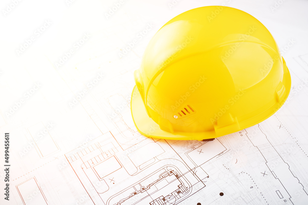 building and architecture background, builder hard hat on engineering blueprints with copy space building and architecture background, builder hard hat on engineering blueprints with copy space