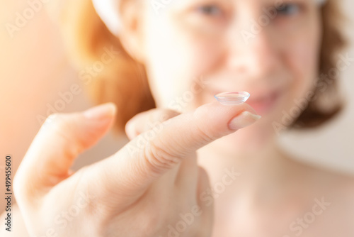 contact lenses woman putting on her eyes in the morning isolated on white background