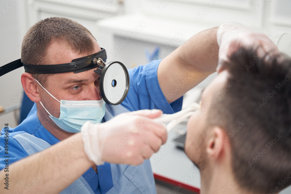 Fototapeta premium Otorhinolaryngologist during consultation with patient in office