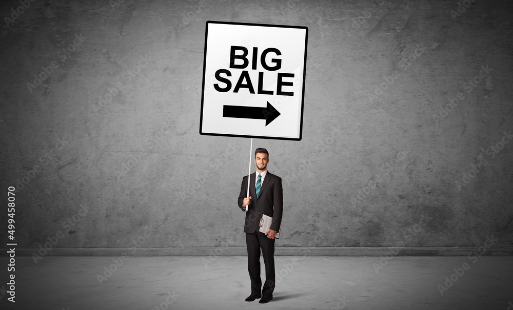 business person holding a traffic sign