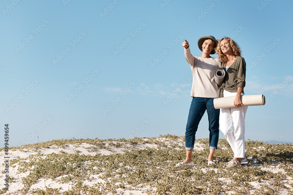 What about there. Full length shot of two attractive mature woman standing with their on the beach. What about there. Full length shot of two attractive mature woman standing with their on the beach.