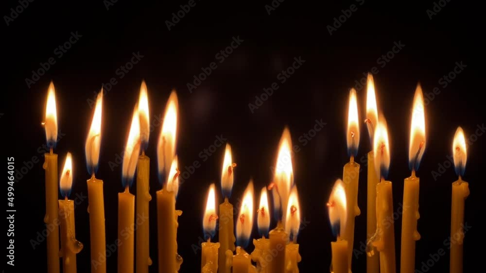 Many wax thin candles burn brightly. Religion concept. High quality 4k footage Many wax thin candles burn brightly. Religion concept. High quality 4k footage