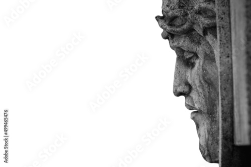 Profile of Jesus Christ in a crown of thorns against white background. Fragment of an ancient statue.