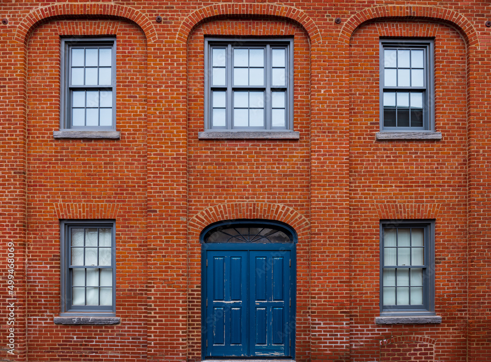 Brick building with a blue entrance door