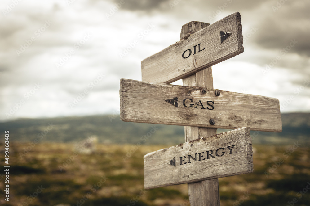 oil gas energy text quote written in wooden signpost outdoors in nature. Moody theme feeling. oil gas energy text quote written in wooden signpost outdoors in nature. Moody theme feeling.