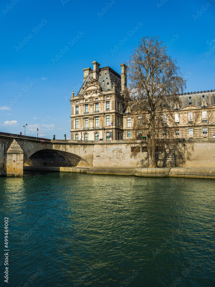 Seine river and the east corner of the Louvre palace with blue sky Seine river and the east corner of the Louvre palace with blue sky
