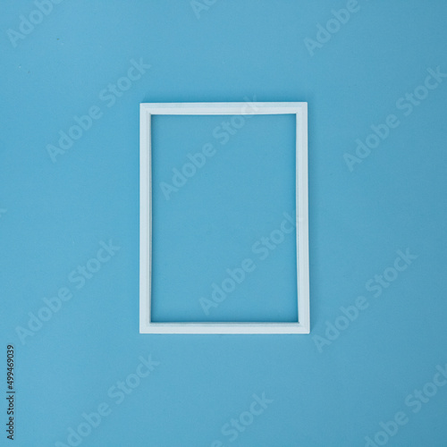 White frame on a blue background. Flat lay concept.