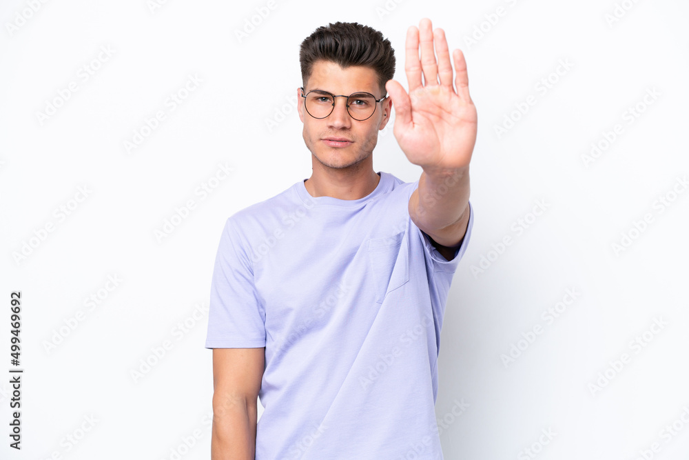 Young caucasian man isolated on white background making stop gesture Young caucasian man isolated on white background making stop gesture