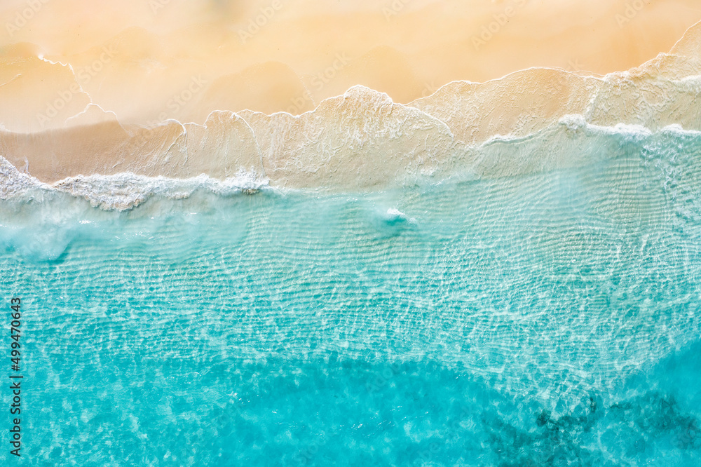 Relaxing aerial beach scene, summer vacation holiday template banner. Waves surf with amazing blue ocean lagoon, sea shore, coastline. Perfect aerial drone top view. Bright beach panorama, seaside