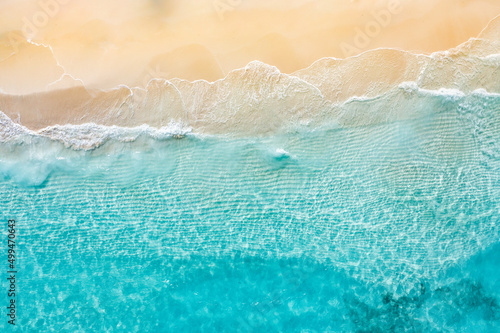 Relaxing aerial beach scene  summer vacation holiday template banner. Waves surf with amazing blue ocean lagoon  sea shore  coastline. Perfect aerial drone top view. Bright beach panorama  seaside