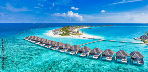Maldives paradise island. Tropical aerial landscape, seascape with jetty, water bungalows villas with amazing sea lagoon beach. Exotic tourism destination, summer vacation background. Aerial travel © icemanphotos