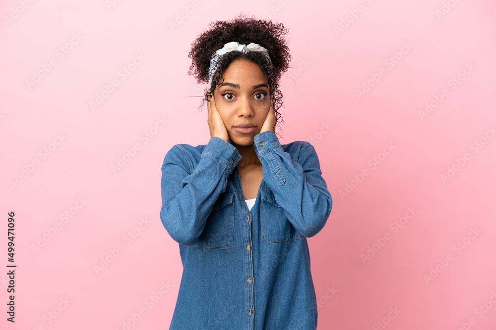 Young latin woman isolated on pink background frustrated and covering ears Young latin woman isolated on pink background frustrated and covering ears