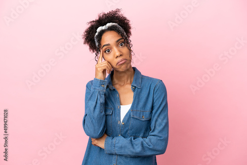 Young latin woman isolated on pink background thinking an idea © luismolinero