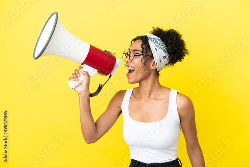 Fotótapéta Young african american woman isolated on yellow background shouting through a me