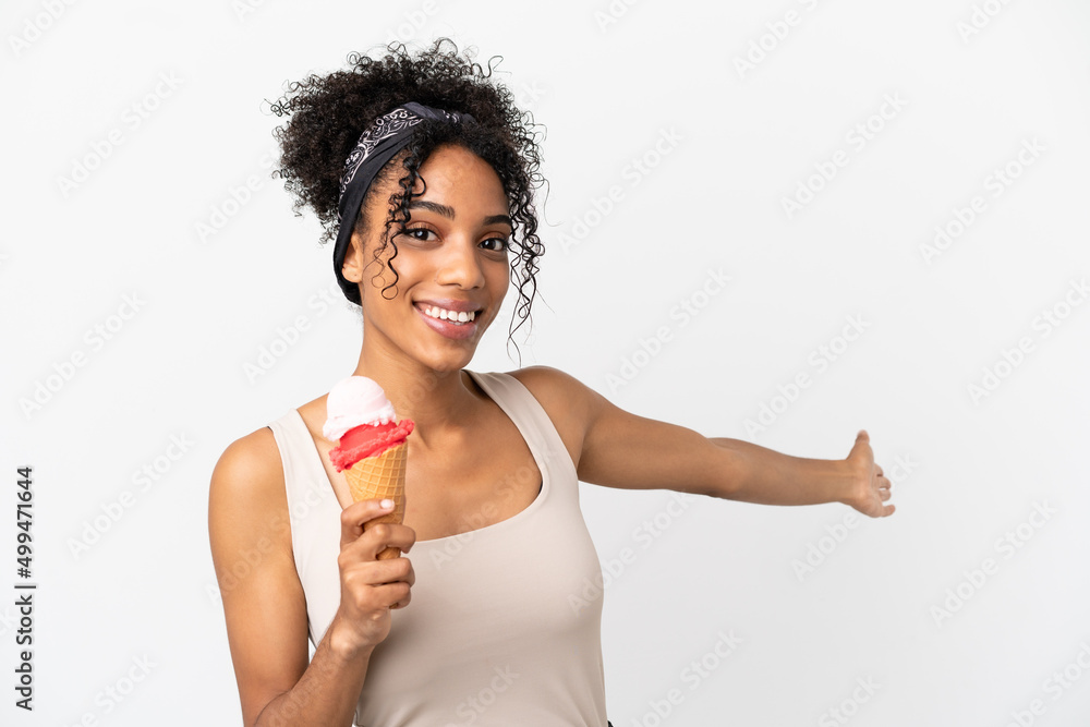 Young african american woman with a cornet ice cream isolated on white background extending hands to the side for inviting to come