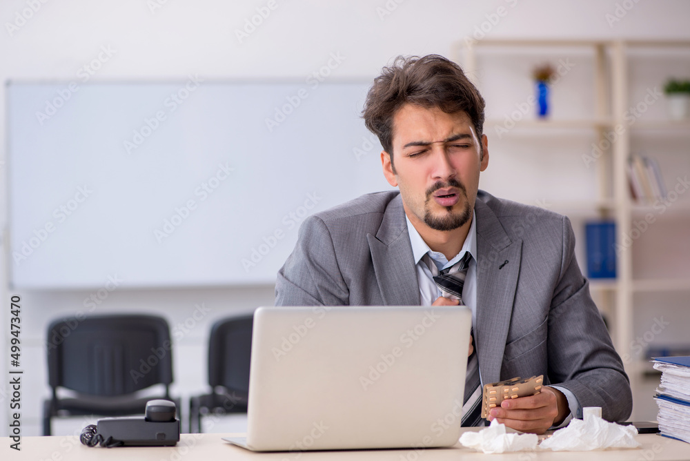 Young businessman employee suffering at workplace Young businessman employee suffering at workplace