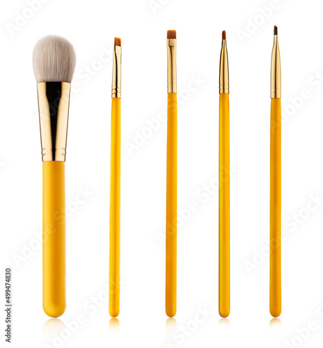 Set of professional makeup concealer powder blush eye shadow eyebrow brushes with yellow handles isolated on white background 