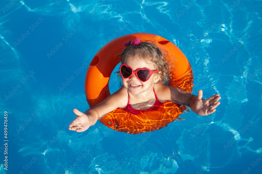 little girl sunning at the pool