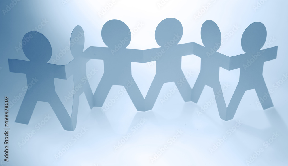 Team of paper chain people united together holding hands Team of paper chain people united together holding hands