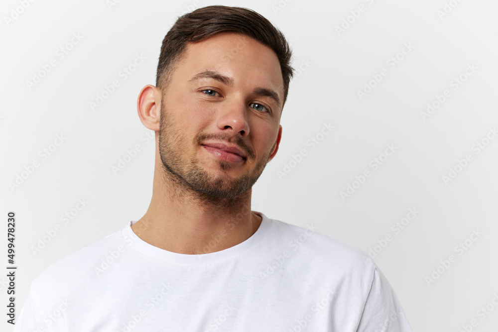 Cheerful cute happy young tanned handsome man in basic t-shirt smile at camera posing isolated on over white studio background. Copy space Banner Mockup. People emotions Lifestyle concept. Portrait Cheerful cute happy young tanned handsome man in basic t-shirt smile at camera posing isolated on over white studio background. Copy space Banner Mockup. People emotions Lifestyle concept. Portrait