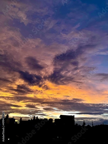 very beautiful twilight sky  a blend of orange and blue colors. beautiful view of the evening sky. clouds  sky and rainbow that adorn the atmosphere in the afternoon. Evening view in Jakarta. blur