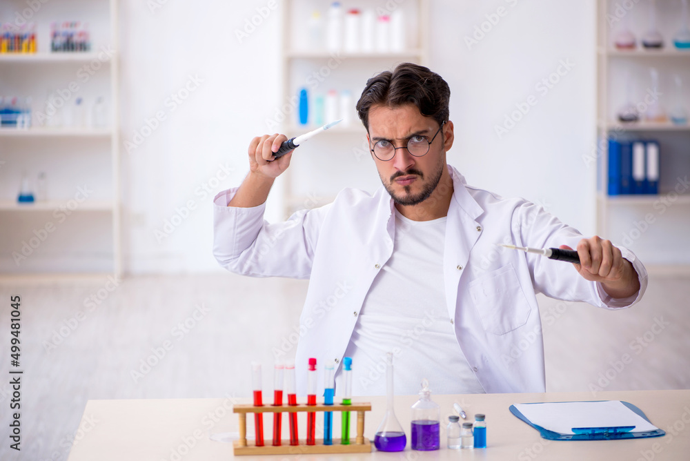 Young male chemist working at the lab Young male chemist working at the lab