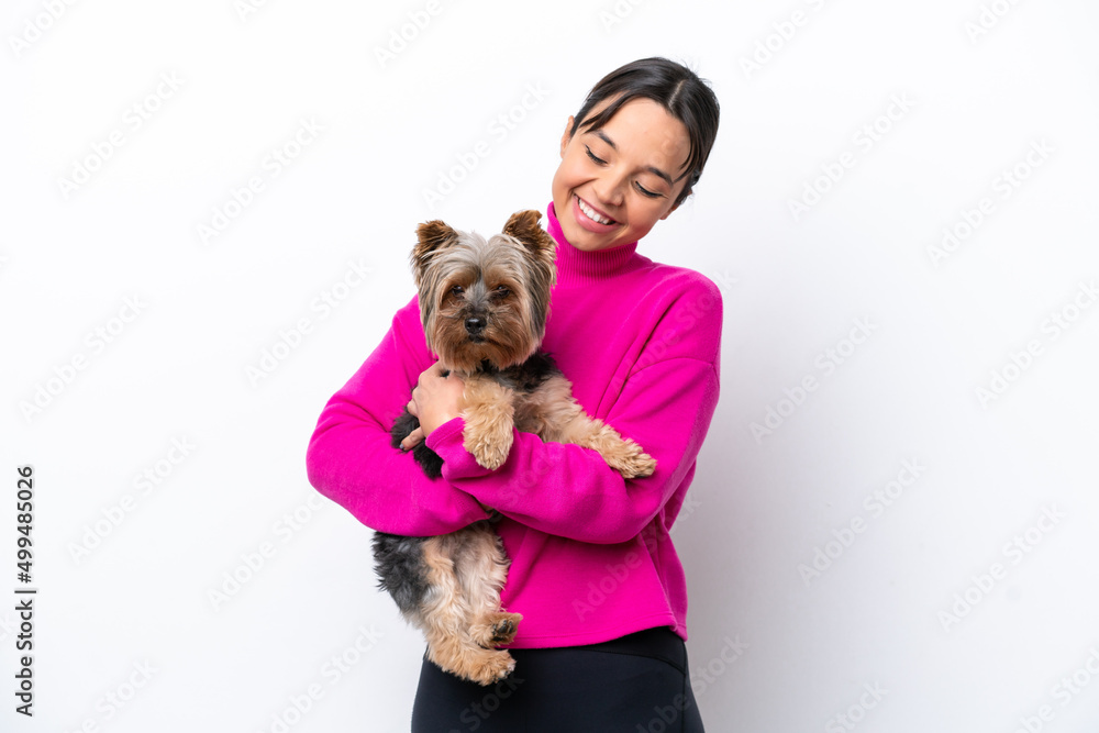 Young hispanic woman holding a dog isolated on white background with happy expression Young hispanic woman holding a dog isolated on white background with happy expression