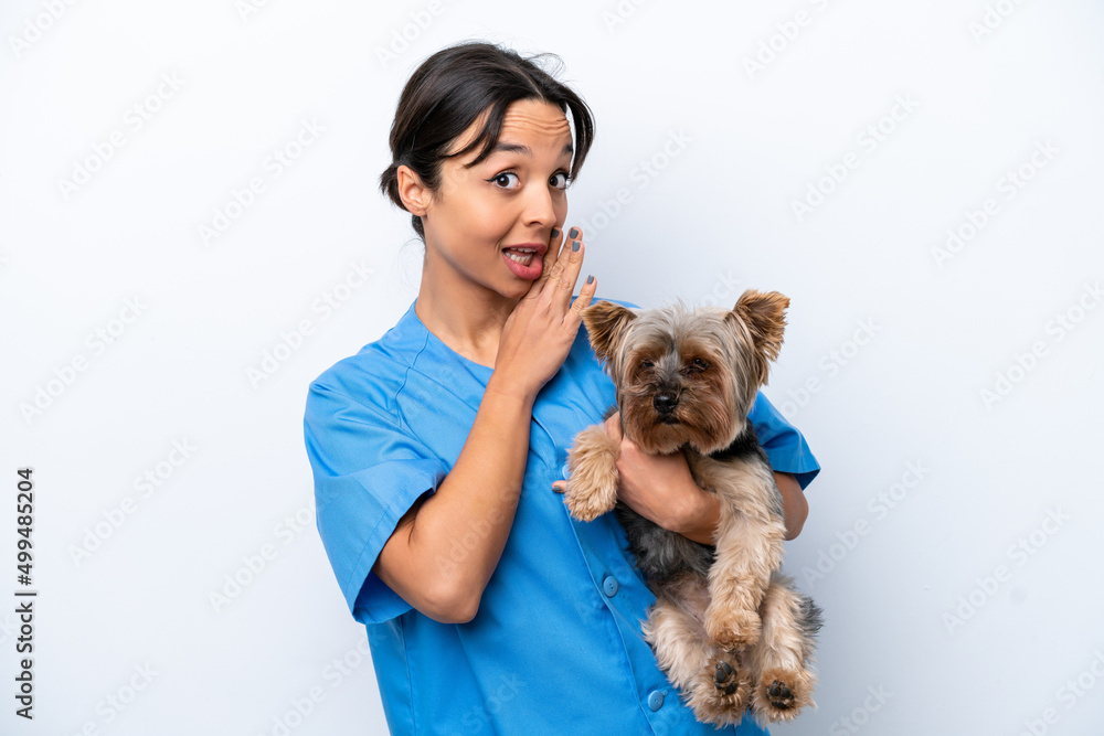 Young veterinarian woman with dog isolated on white background whispering something Young veterinarian woman with dog isolated on white background whispering something