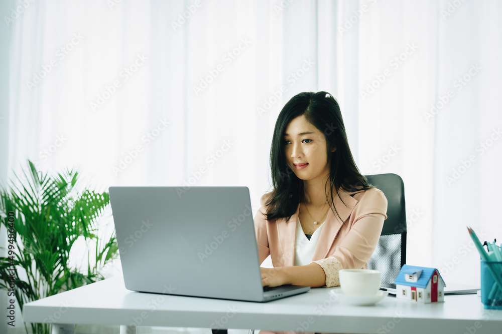 Entrepreneurs, business owners, accountants, real estate agents, Portrait of asian women using computer to calculate assess financial risks to buy house. Entrepreneurs, business owners, accountants, real estate agents, Portrait of asian women using computer to calculate assess financial risks to buy house.