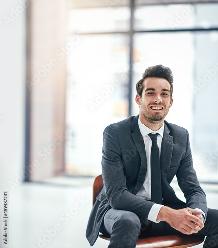 Happiness is a job that you love. Portrait of a happy young businessman posing in the office.