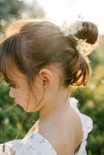Happy little girl in the field of Queen Anne's Lace flower