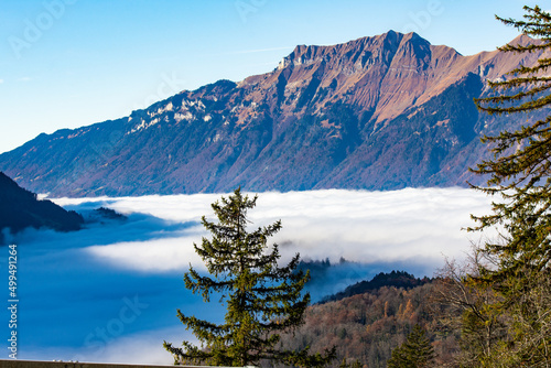 Swiss alps with the blanket of clouds in the valey photo