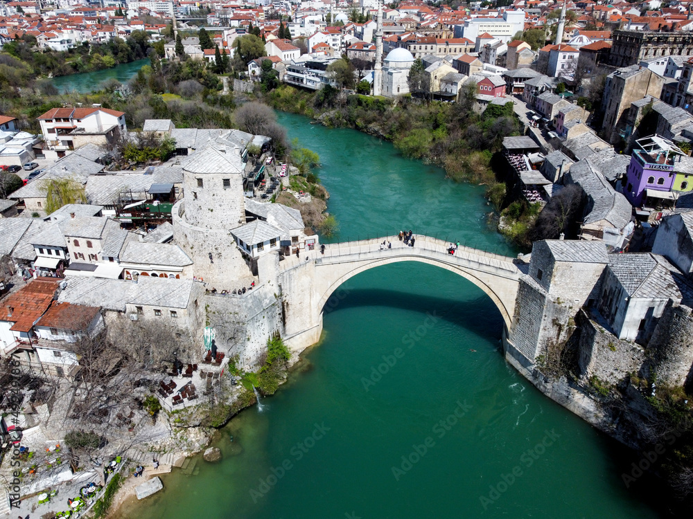 Old Bridge and Neretva river in Mostar, Bosnia and Herzegovina. Panoramic view of Mostar in spring, aerial drone view. 