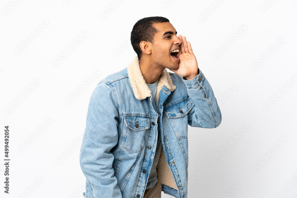 African American man over isolated white background shouting with mouth wide open to the side African American man over isolated white background shouting with mouth wide open to the side