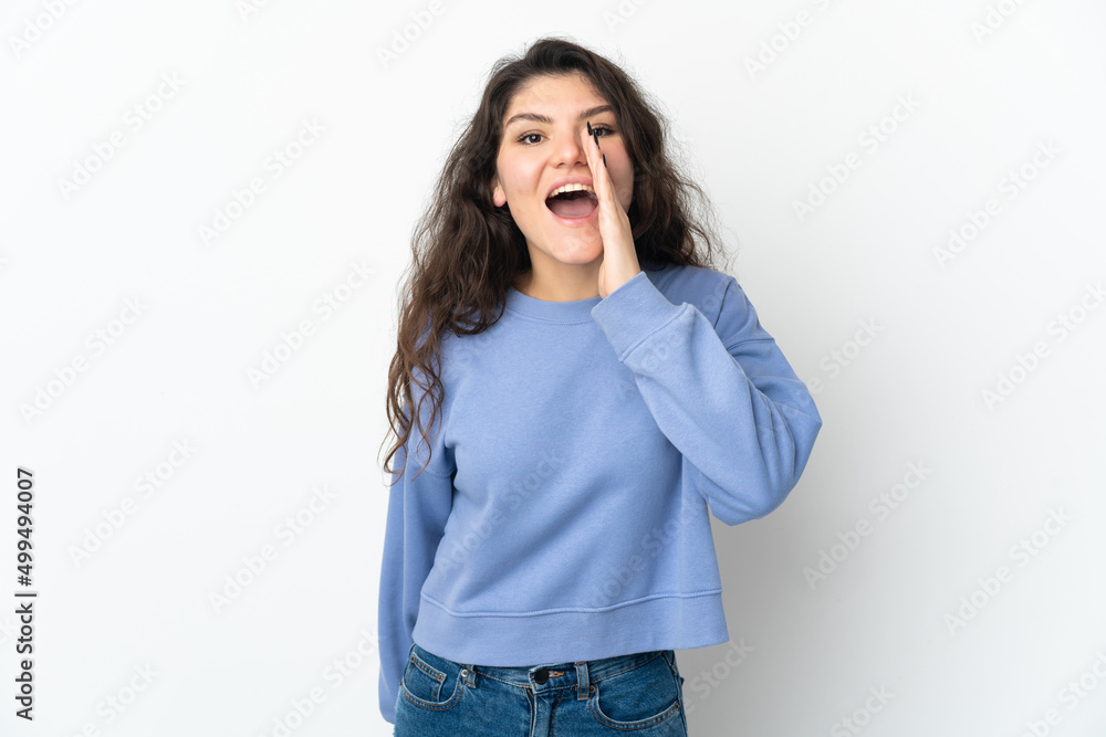 Teenager Russian girl isolated on white background shouting with mouth wide open Teenager Russian girl isolated on white background shouting with mouth wide open