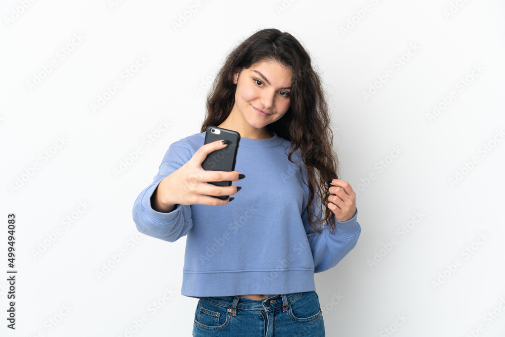 Teenager Russian girl isolated on white background making a selfie Teenager Russian girl isolated on white background making a selfie