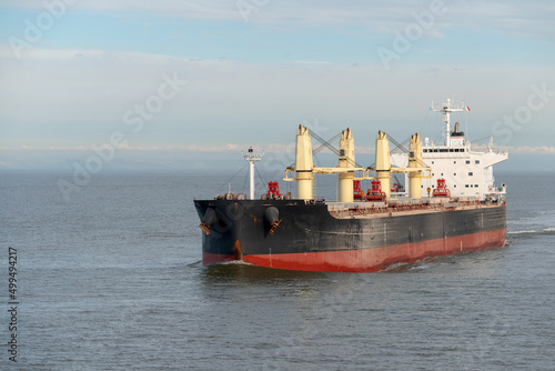 Large bulk cargo ship underway. Big bulker vessel cargo export and import operation.