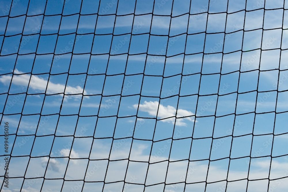 clouds behind a net. concept of deprivation of liberty clouds behind a net. concept of deprivation of liberty