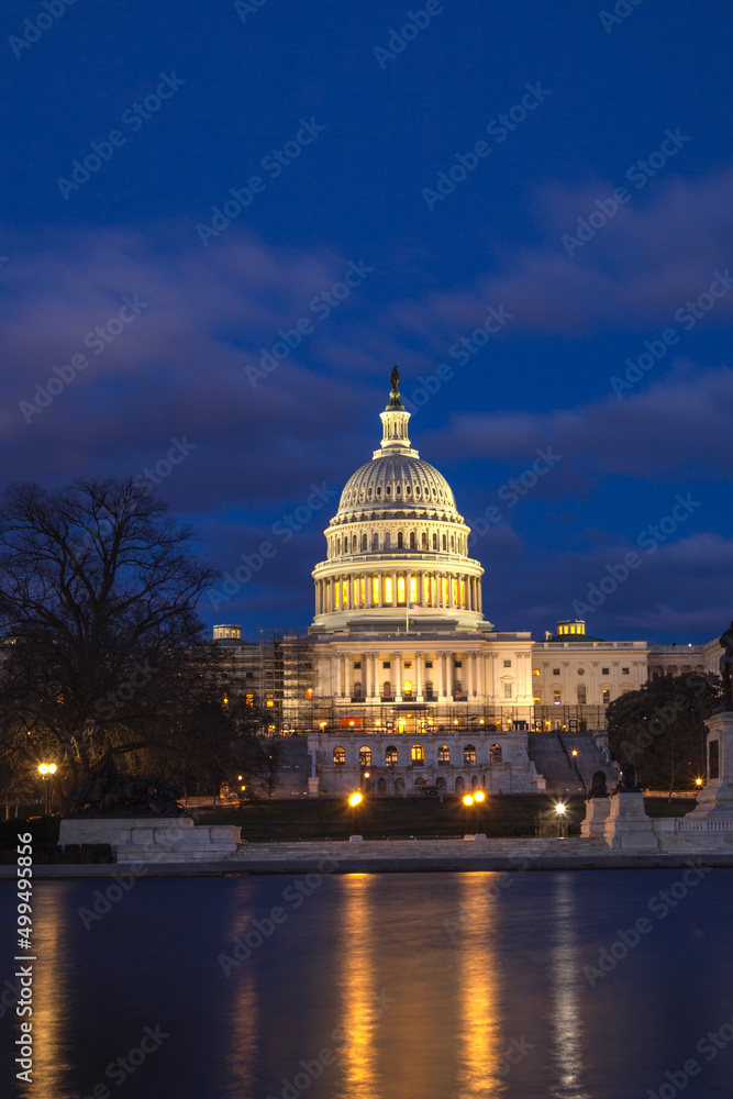 U.S. Capitol building at twilight reflecting off of the reflecting pool