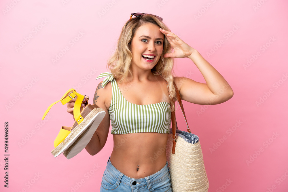 Young Brazilian woman in swimsuit in summer holidays isolated on pink background with surprise and shocked facial expression Young Brazilian woman in swimsuit in summer holidays isolated on pink background with surprise and shocked facial expression