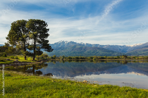 Almanzor peak, in the Gredos mountain, reflected in the water of a lake on a sunny day. Copy space. Selective focus.