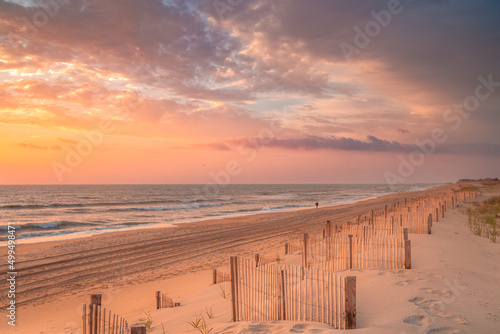 Lone individual going for an early morning walk at sunrise along the Outer Banks of North Carolina near Nags Head