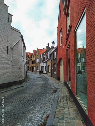 A street with colorful historical brick houses in Bruges, Belgium