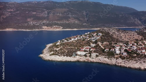 Panoramic view of Kas town in Turley with its mountains and blue seascape filmed by drone. An aerial footage of coastal city located on the rock and surrounded by the ocean. Famous travel destinations photo