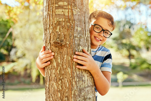 I think Ive found a pretty good hiding spot. Portrait of a little boy playing at the park. © T Chithambo/peopleimages.com