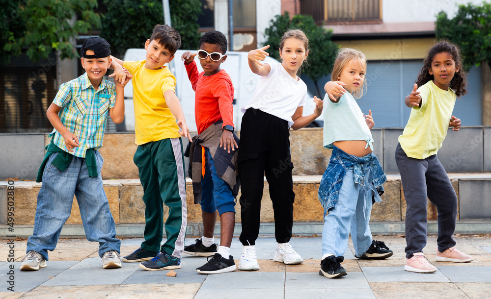 Modern tweens dancing on summer street. Urban lifestyle. Hip-hop generation