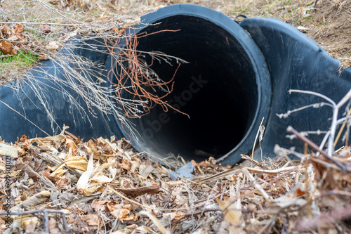 HDPE drainage culvert under a road entrance. Pipe is used to convey stormwater between ditches. photo