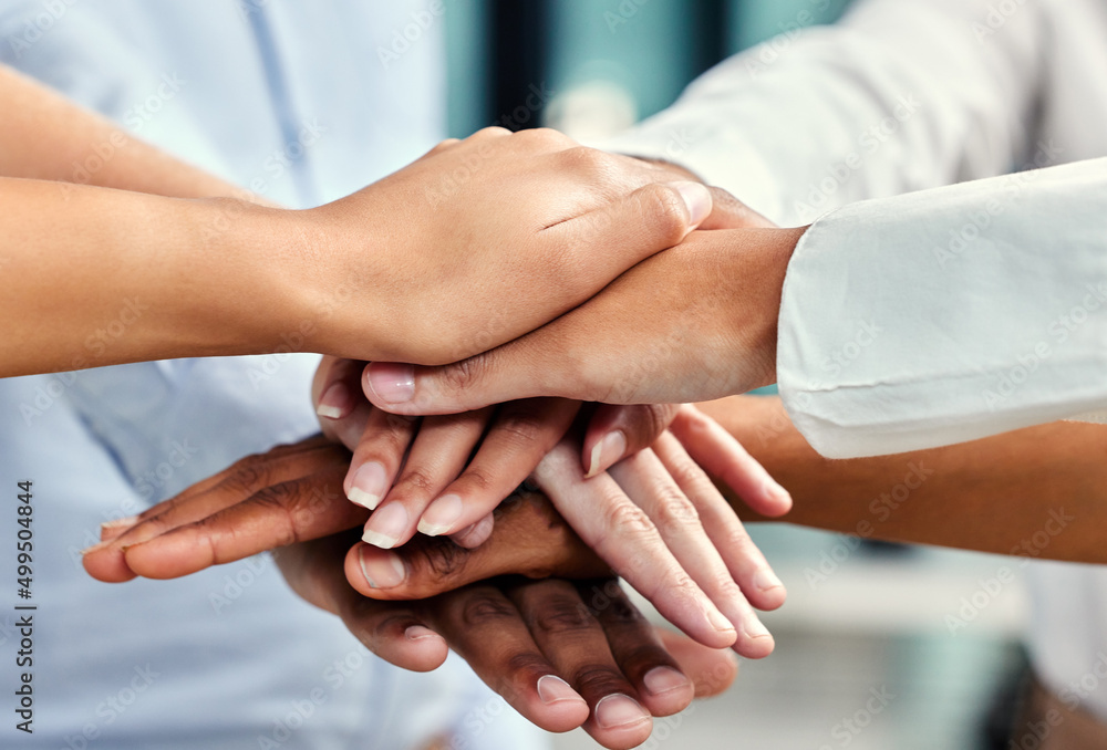 United in their pursuit of success. Cropped shot of a group of unrecognizable businesspeoples hands stacked while in a huddle in their office. United in their pursuit of success. Cropped shot of a group of unrecognizable businesspeoples hands stacked while in a huddle in their office.