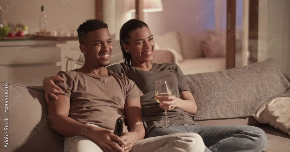 Diverse couple watching TV during date Diverse couple watching TV during date